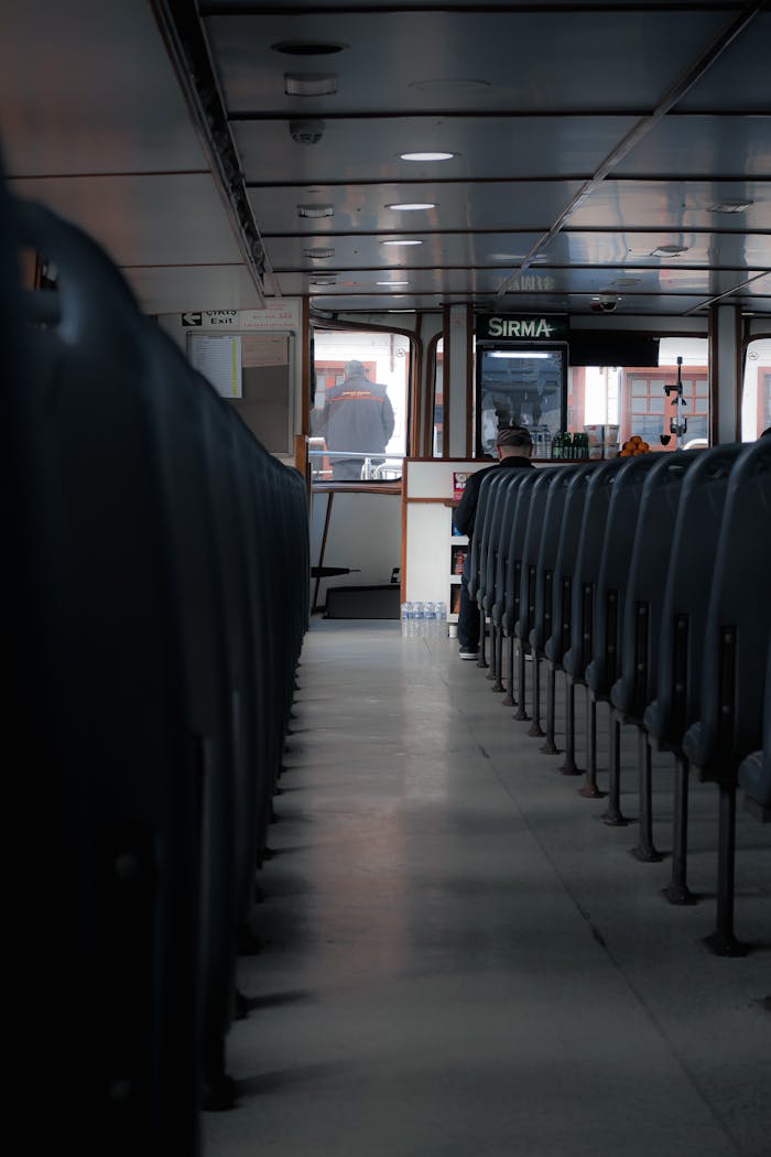 Services-01 View of empty seats inside a public transportation vehicle with a focus on interior design.